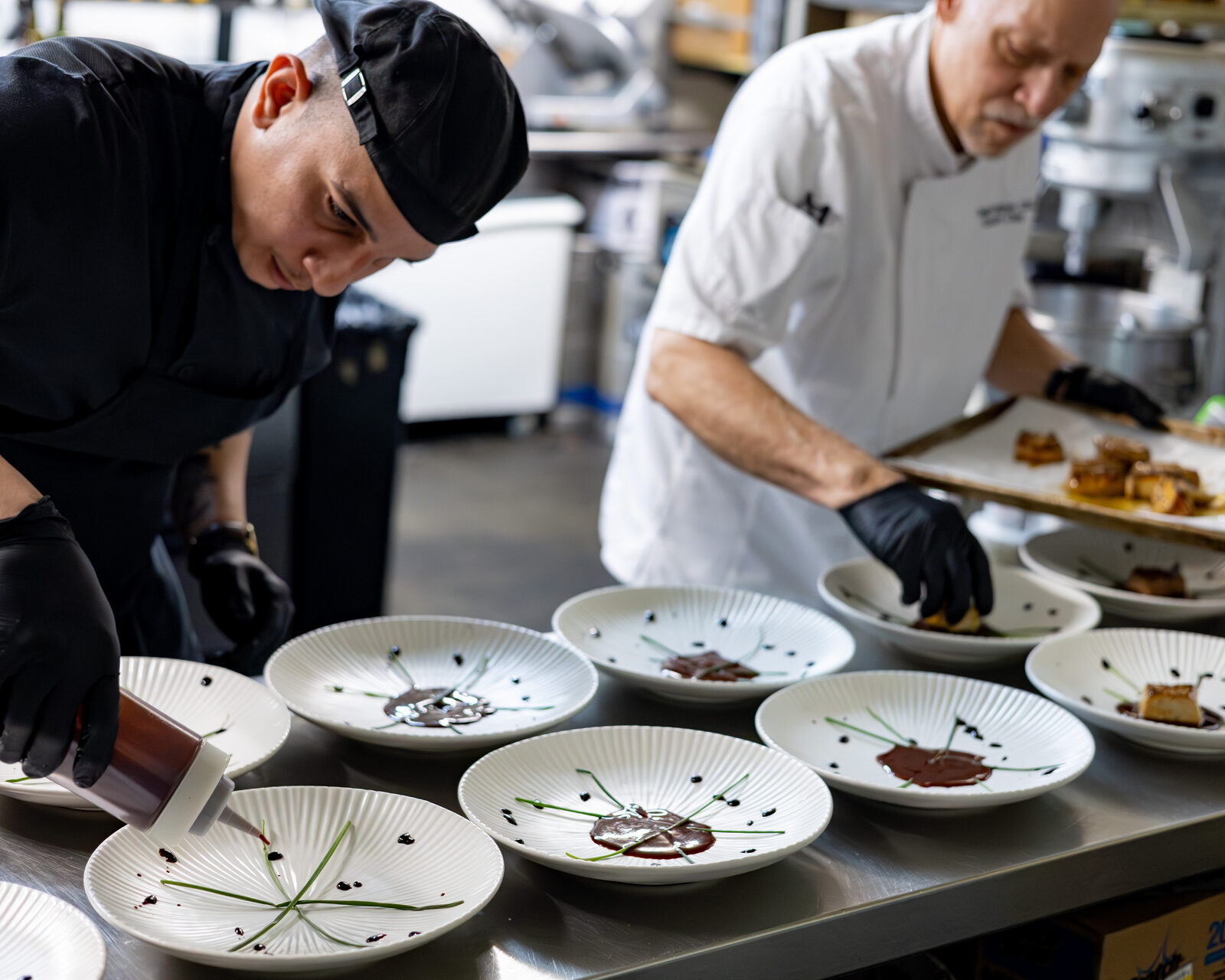 Chefs plating in kitchen